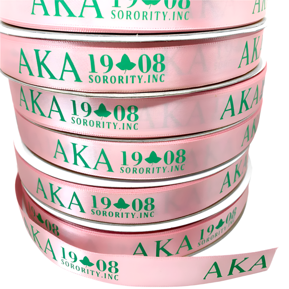 Stack of pink ribbons with 'AKA 1908 Sorority, Inc.' text on a white background
