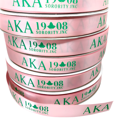 Stack of pink ribbons with 'AKA 1908 Sorority, Inc.' text on a white background
