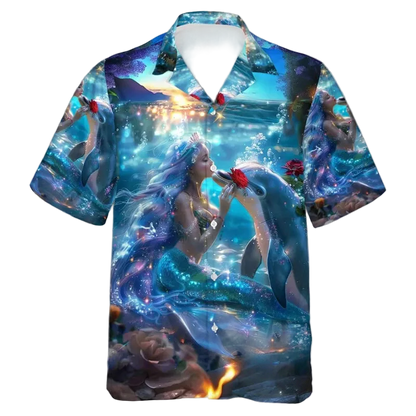 A short-sleeve button-up Hawaiian-style shirt with an all-over fantasy print of a mermaid kissing a dolphin underwater, featuring blue, teal, purple, and orange tones with a white collar.