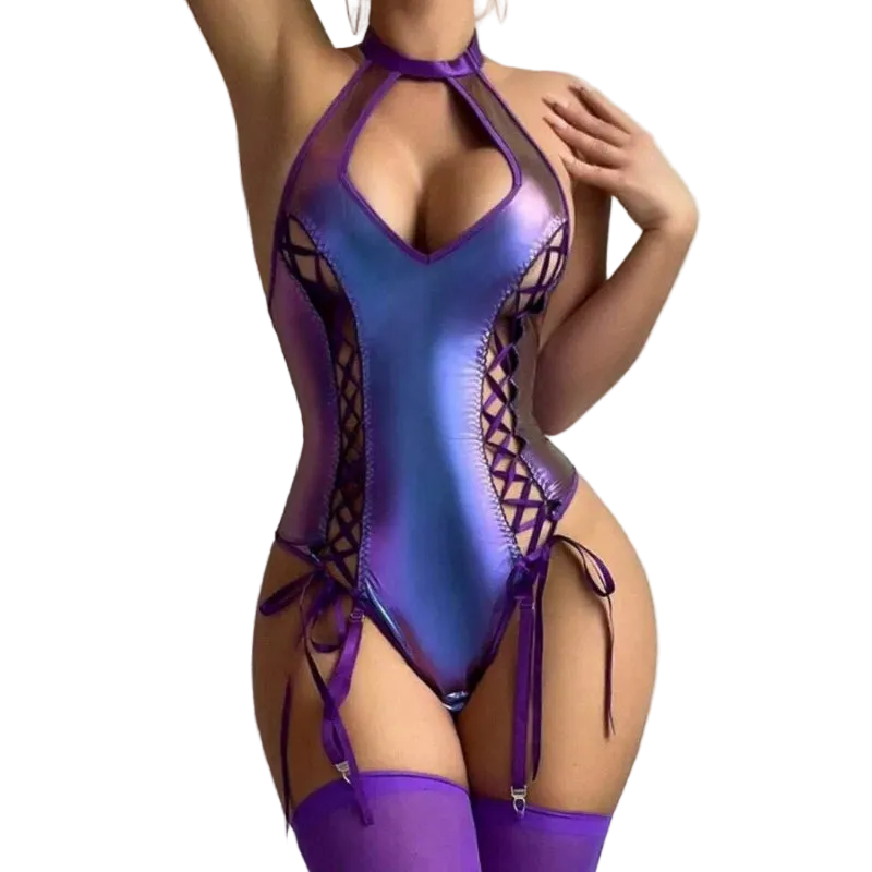A model wearing a shiny iridescent purple bodysuit with side cutouts and lace-up details, paired with matching purple thigh-high stockings, against a plain light gray wall.