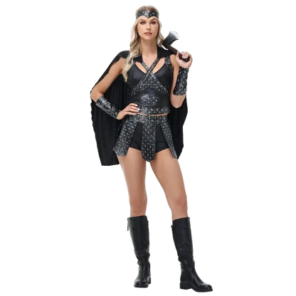 A woman modeling a black and silver warrior costume with a matching headband, arm cuffs, mini skirt, and black cape, holding a toy axe against a plain white background.