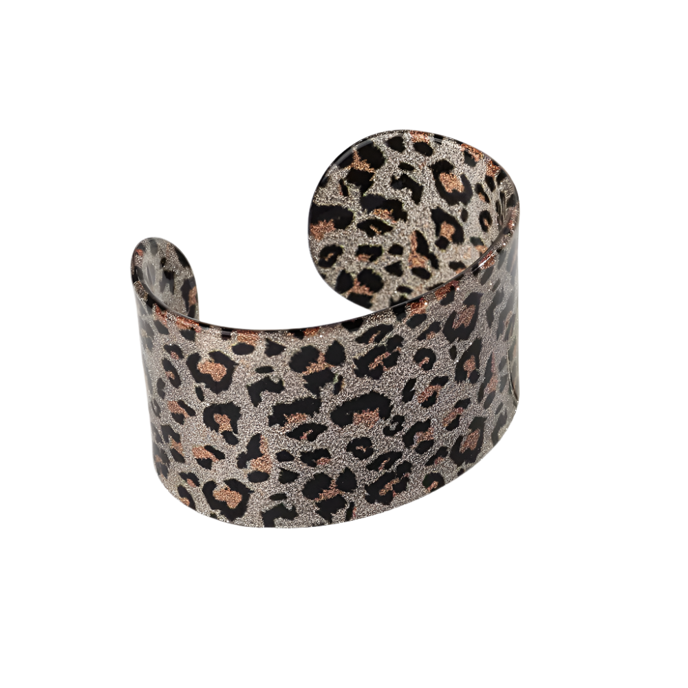 Bold leopard print wide cuff bangle featuring hollow geometric patterns and premium resin design for resort wear and theme nights

