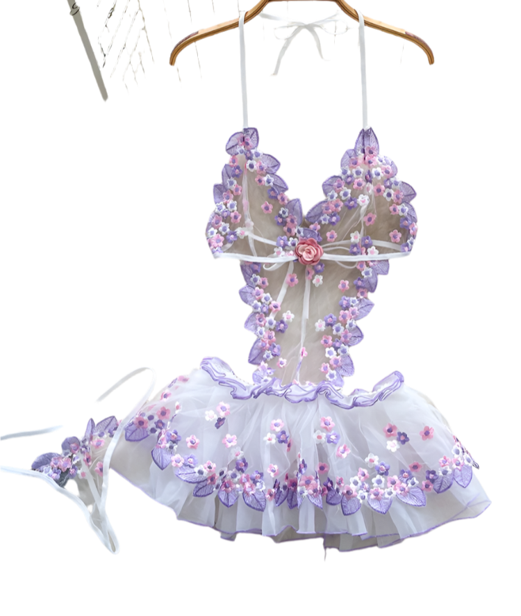 Floral embroidered dress on a hanger with a soft white background