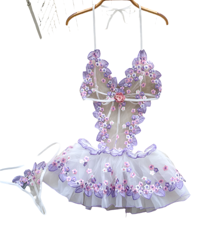 Floral embroidered dress on a hanger with a soft white background