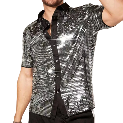 Person wearing a sparkling silver shirt against a neutral background