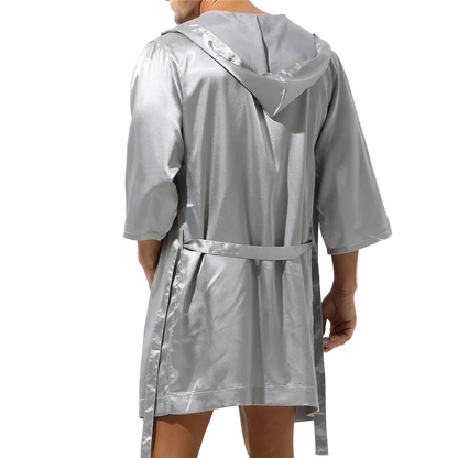 Silver raincoat worn by a person on a white background