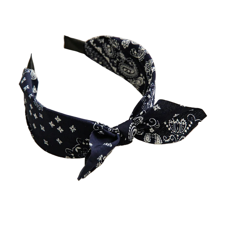 Navy blue headband with white patterns on a beige tray