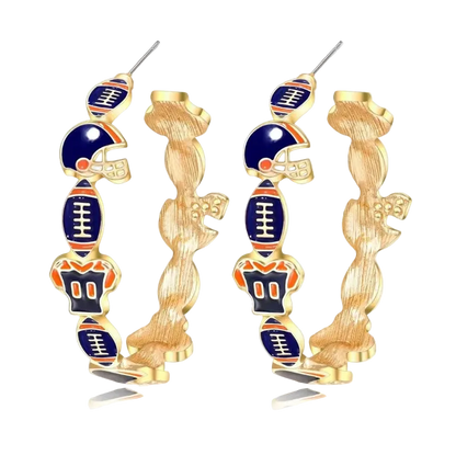 A pair of gold hoop earrings featuring stacked football-themed charms, including helmets, footballs, and a large football at the bottom, with navy blue and orange enamel details, shown on a white background with a soft reflection.