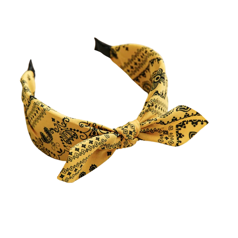 Yellow headband with black patterns on a beige tray