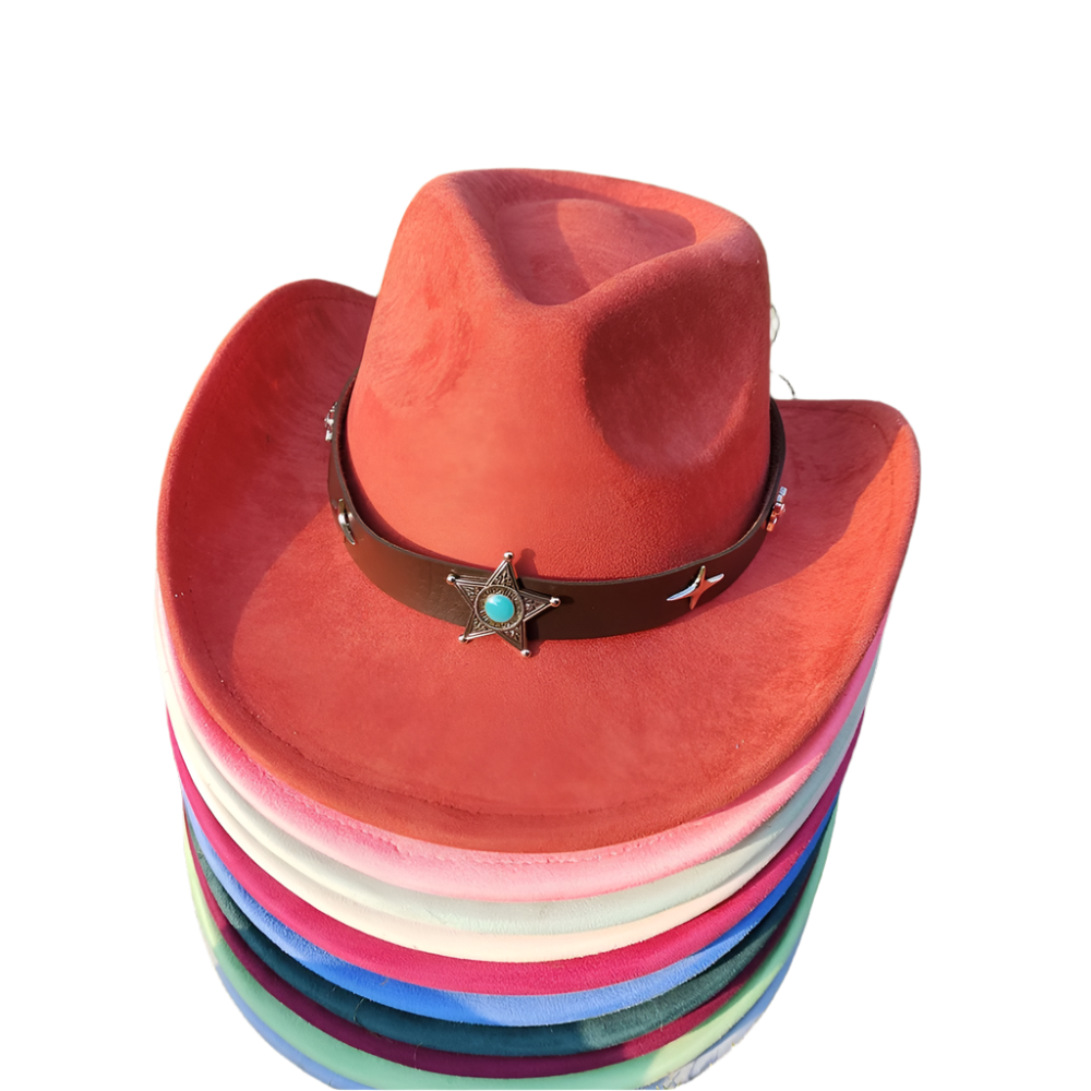 Stack of colorful cowboy hats with a red top hat featuring a star and turquoise stone on grass.