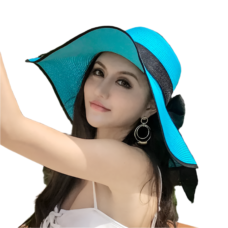 Woman wearing a blue and black sun hat outdoors with greenery in the background