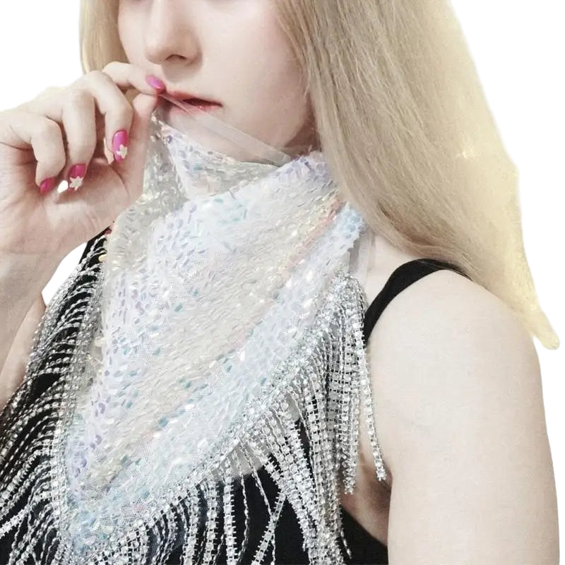 Person wearing a sparkling silver top with a blurred background