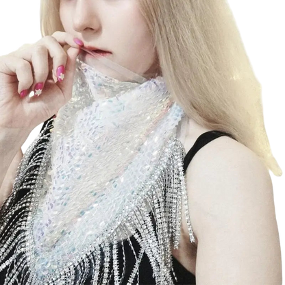 Person wearing a sparkling silver top with a blurred background