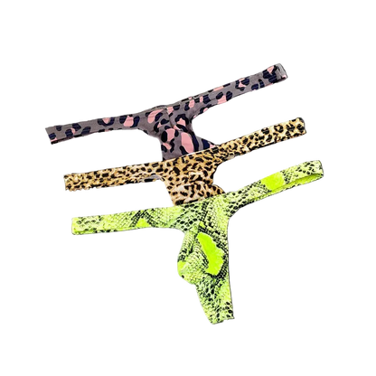 Three pairs of leopard-print thong underwear stacked diagonally on a dark gray background. The top pair is black and pink leopard print, the middle is tan and brown leopard print, and the bottom is a bright neon green and black snakeskin print.