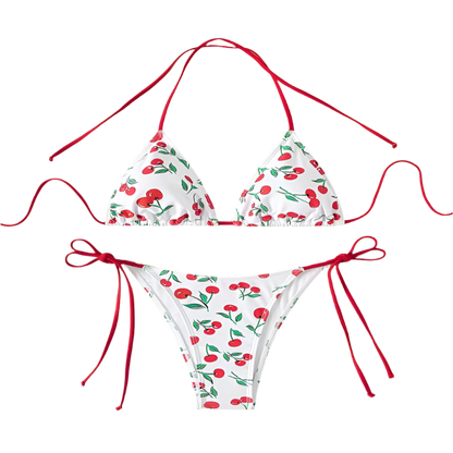 A white bikini with a cherry print. It features a classic triangle top and tie-side bottoms with red strings, giving it a playful and fruity look.
