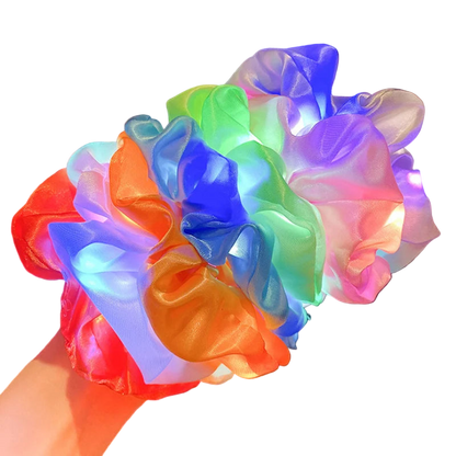 Colorful LED scrunchies on a blurred indoor background