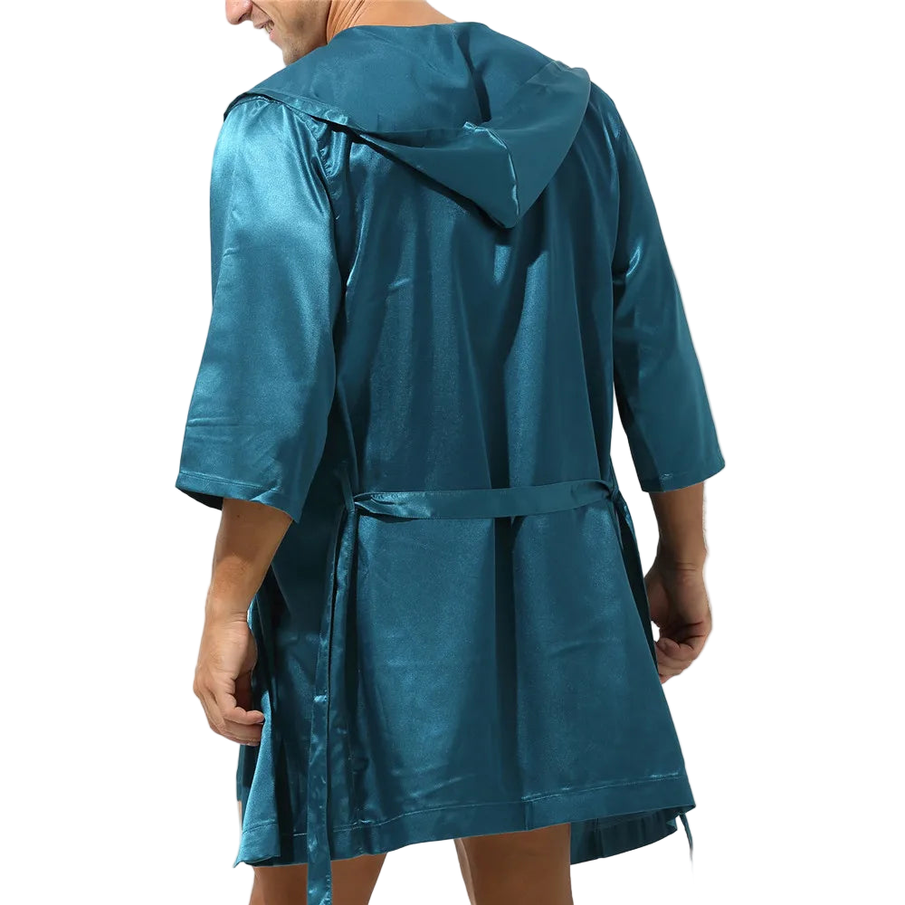 Teal raincoat worn by a person on a white background