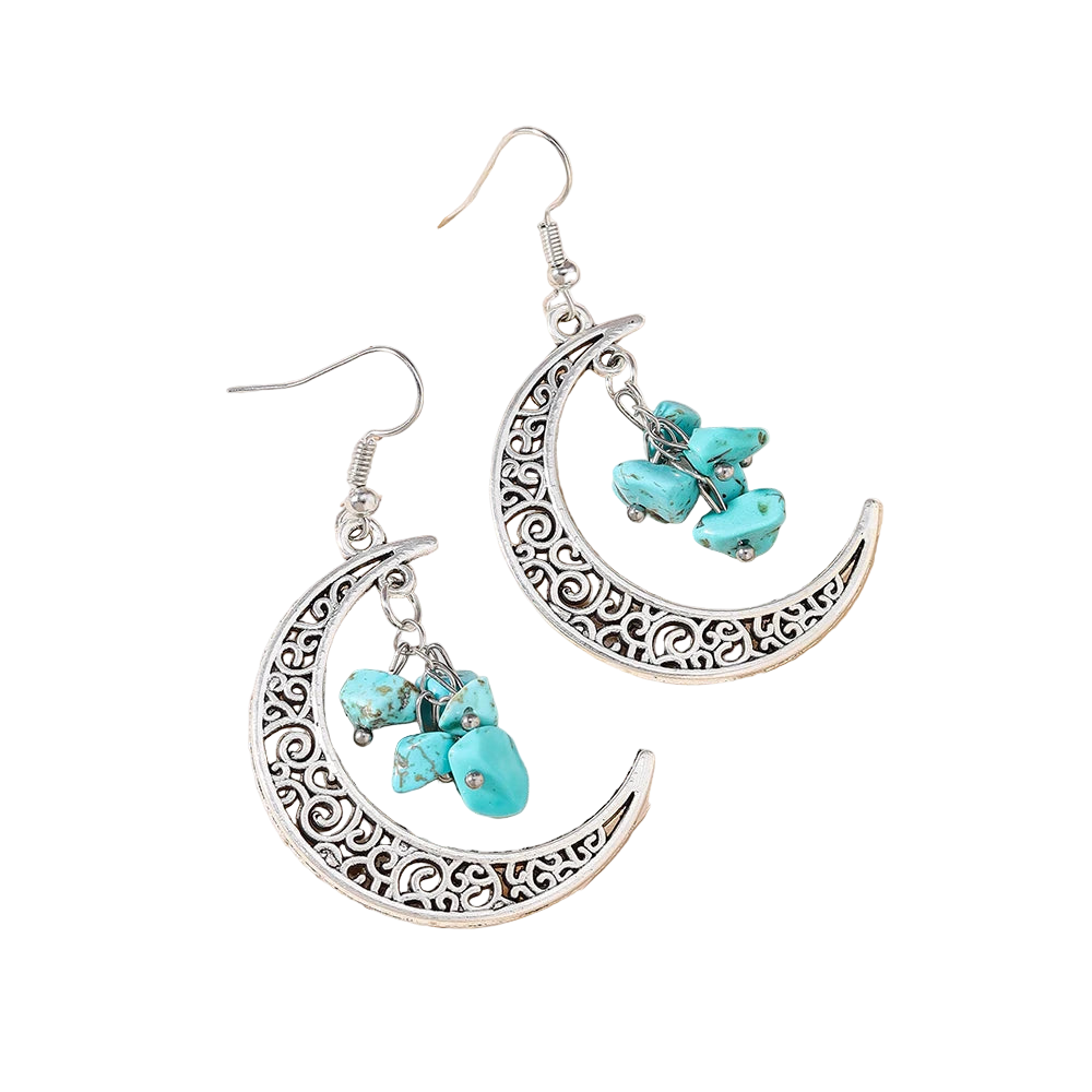Silver earrings with turquoise stones on a textured beige surface
