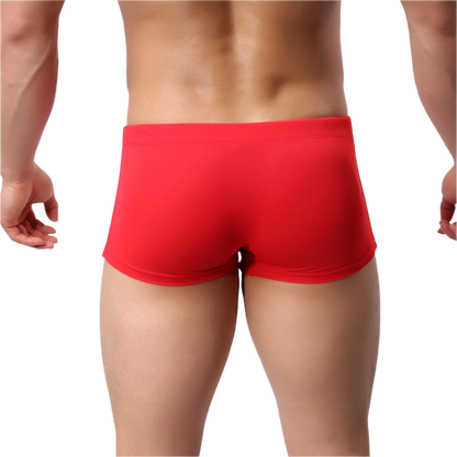 Red swim trunks with white drawstring and 'ARIGREBEN' branding