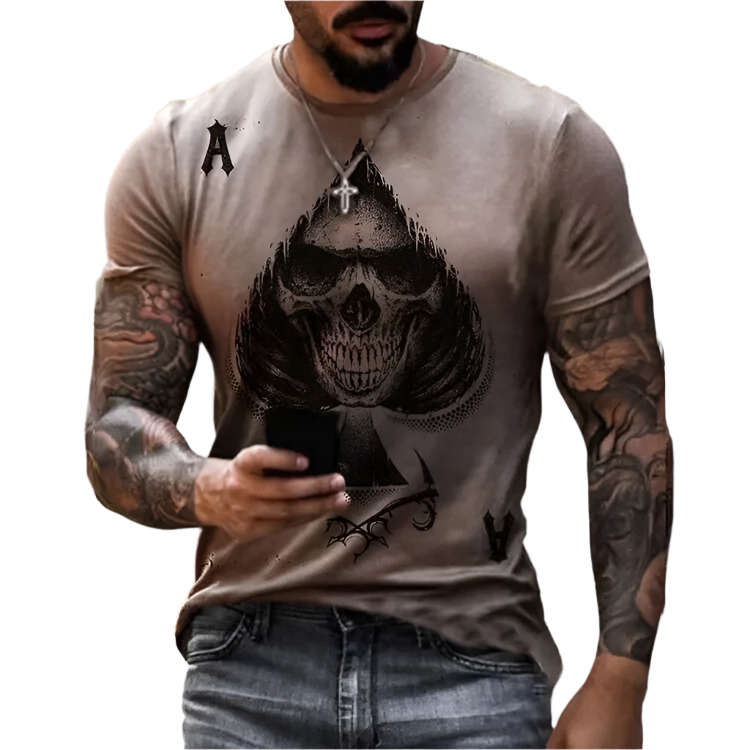 Man wearing a t-shirt with a skull design and tattoos on arms against a blurred background