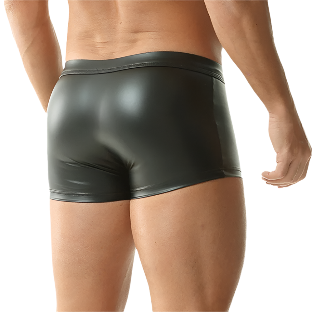 Person wearing shiny black underwear on a white background