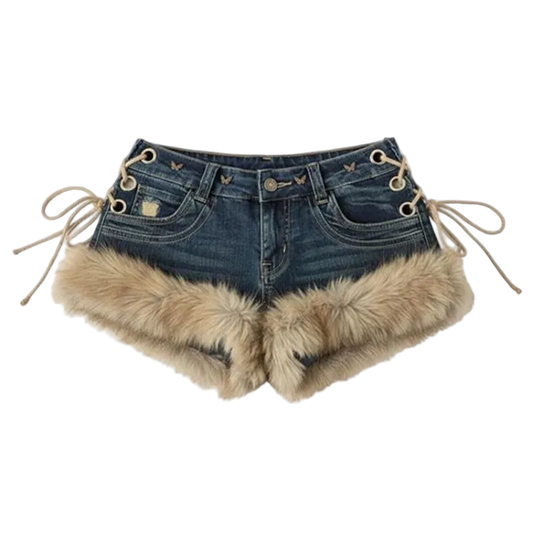Dark blue denim shorts with beige faux fur trim at the hem and beige lace-up details on the sides, shown against a light gray background.