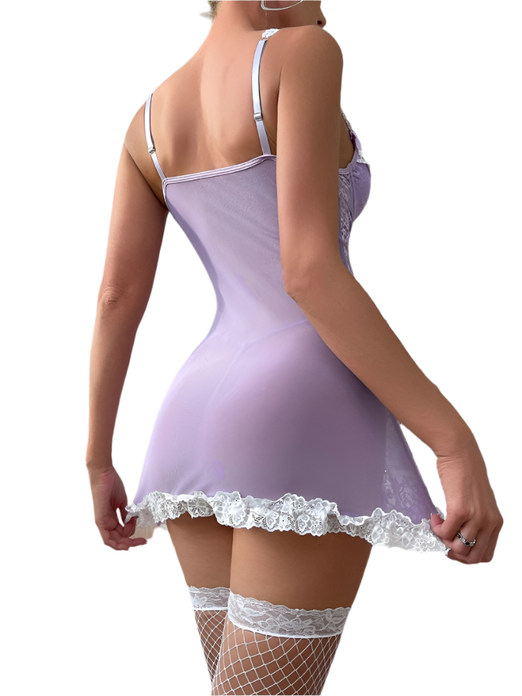 Woman wearing a lavender nightgown with lace trim in a bedroom setting.