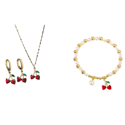 Jewelry set with cherry-themed earrings and necklace on a black background, and pearl bracelet with cherry charm on a white background.