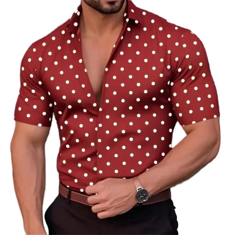 Man wearing a red shirt with white polka dots, posing against a blurred background