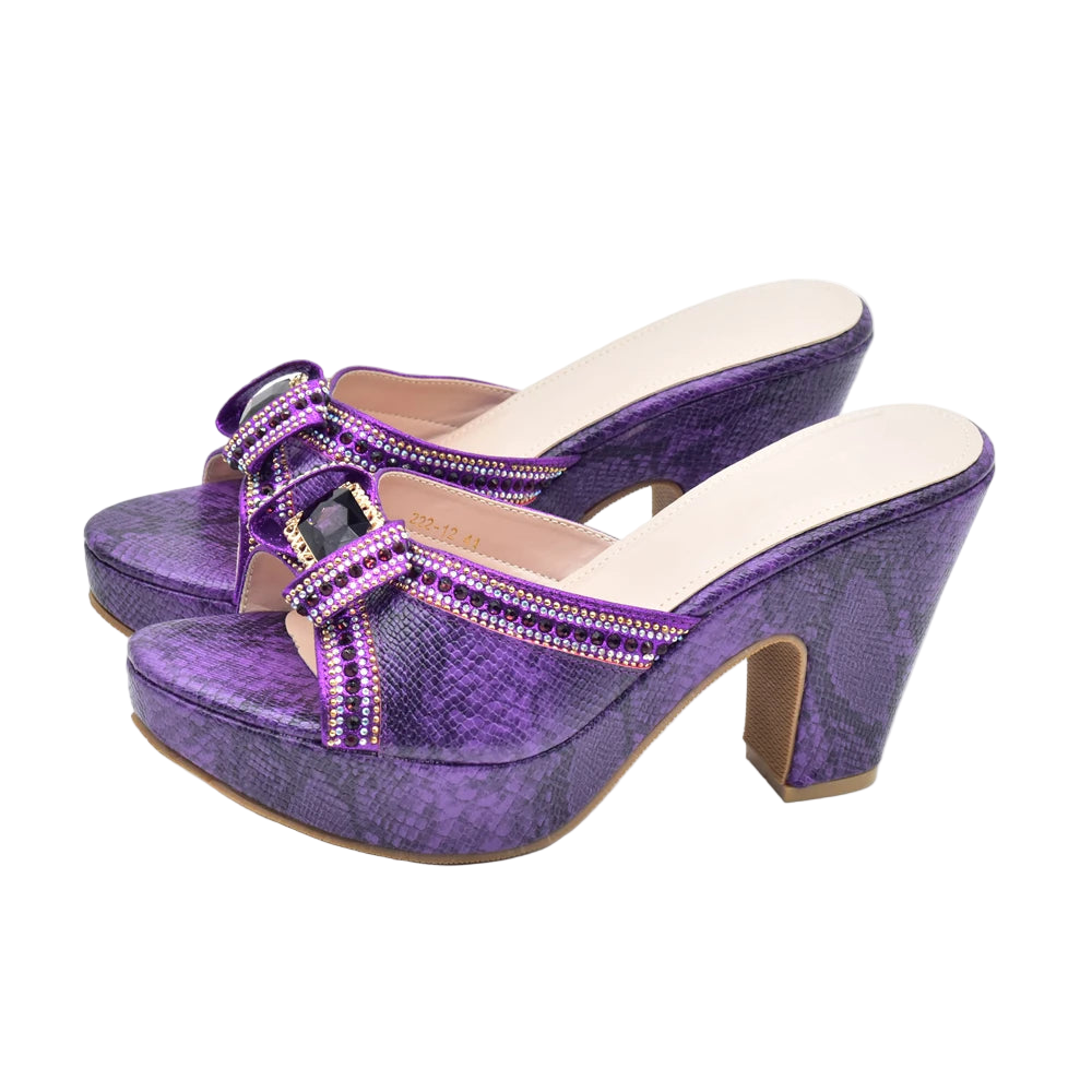 Purple high-heeled shoes with embellishments on a white background