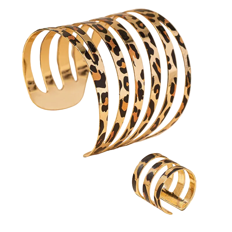 Set of gold and leopard print bangles on a beige background
