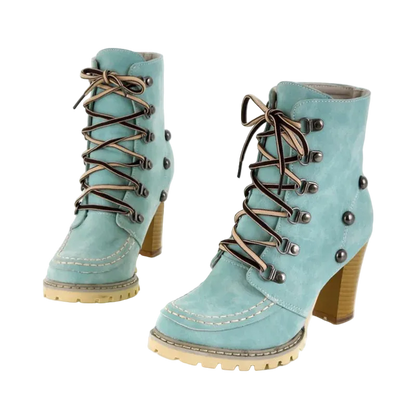 Pair of light blue boots with brown laces and buttons on a white background