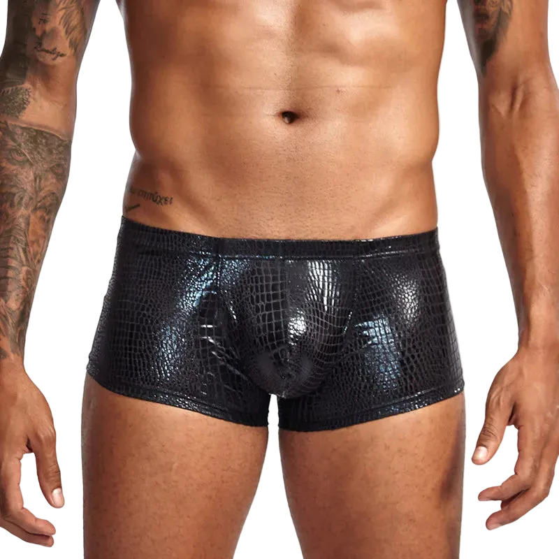 Black crocodile-patterned underwear worn by a person on a white background