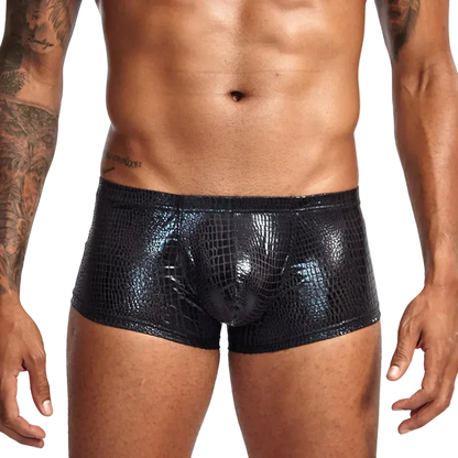 Black crocodile-patterned underwear worn by a person on a white background