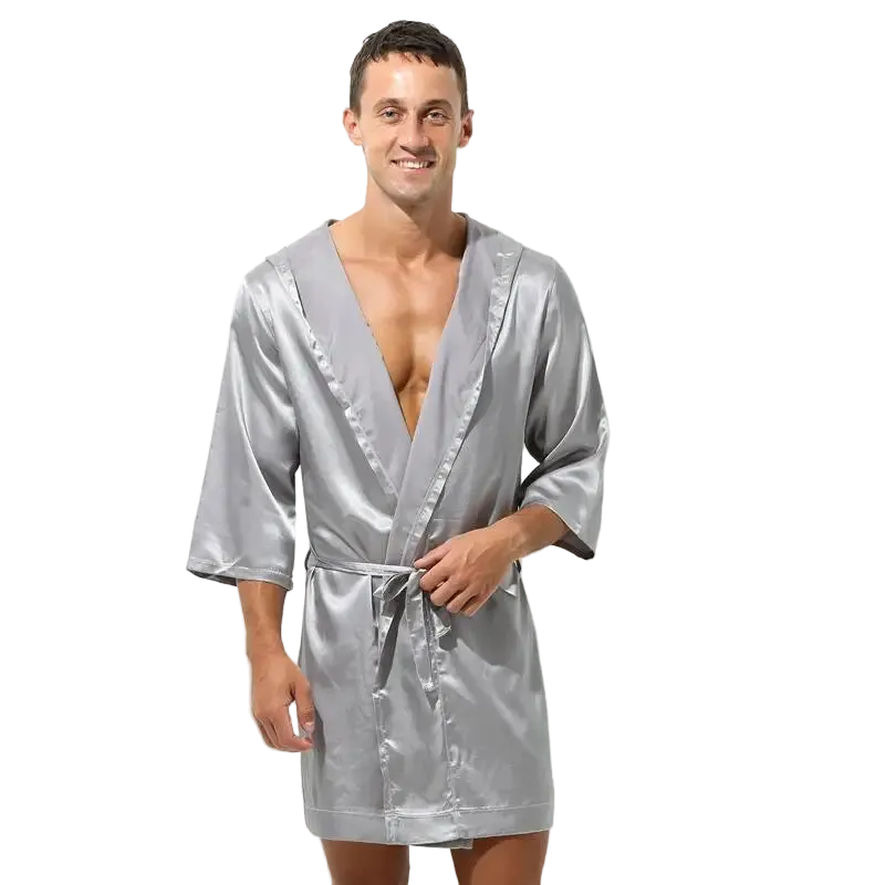 Man wearing a silver satin robe on a white background