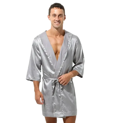 Man wearing a silver satin robe on a white background