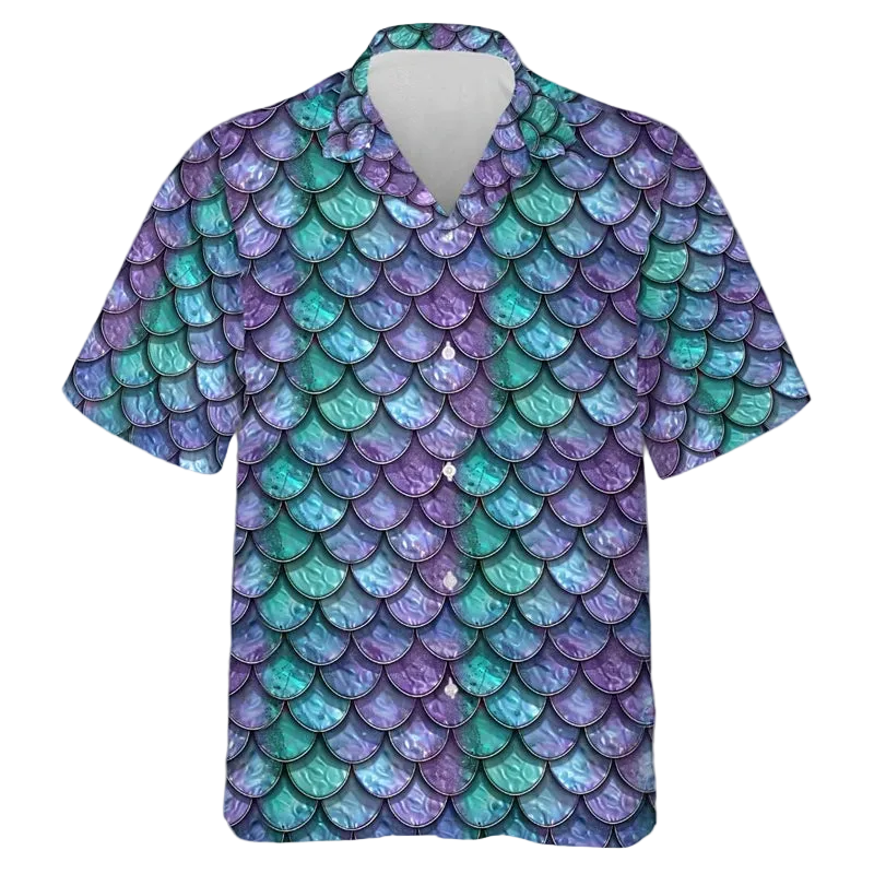 A short-sleeve button-up camp shirt featuring an all-over mermaid scale pattern in shades of purple, teal, and blue, displayed on a clean white background.
