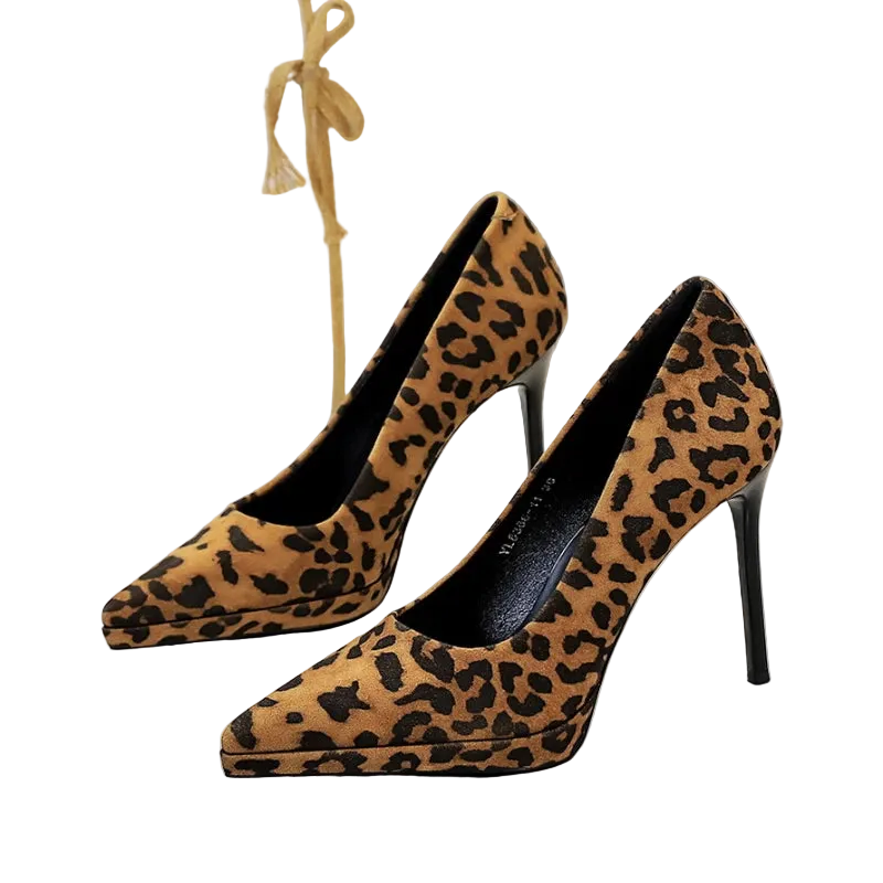 Leopard print high-heeled shoes on a white surface with a blurred background