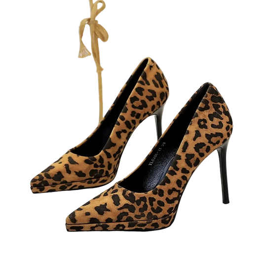 Leopard print high-heeled shoes on a white surface with a blurred background