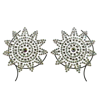 Pair of decorative hair clips with starburst design and rhinestones on a white background