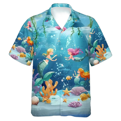 A short-sleeve button-up camp shirt with a vibrant cartoon underwater mermaid print, featuring mermaids, corals, starfish, and bubbles on a blue background.