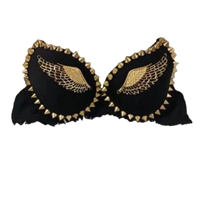 Black bralette with gold wing embroidery and gold spiked trim, displayed on a white faux fur background.