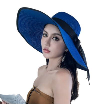 Woman wearing a blue hat indoors with a neutral background