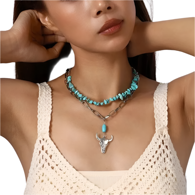 Woman wearing a turquoise beaded necklace with a silver bull head pendant.