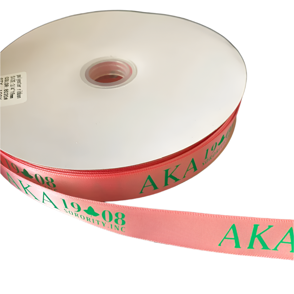 Roll of pink ribbon with 'AKA 1908' text on a black background