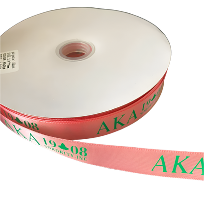 Roll of pink ribbon with 'AKA 1908' text on a black background