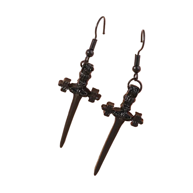 Black dagger-shaped earrings on a beige background