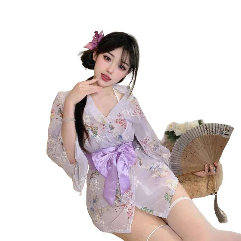 Woman in a floral kimono with a purple bow sitting on a couch.