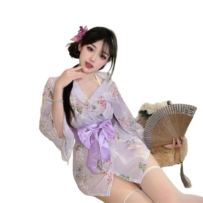 Woman in a floral kimono with a purple bow sitting on a couch.