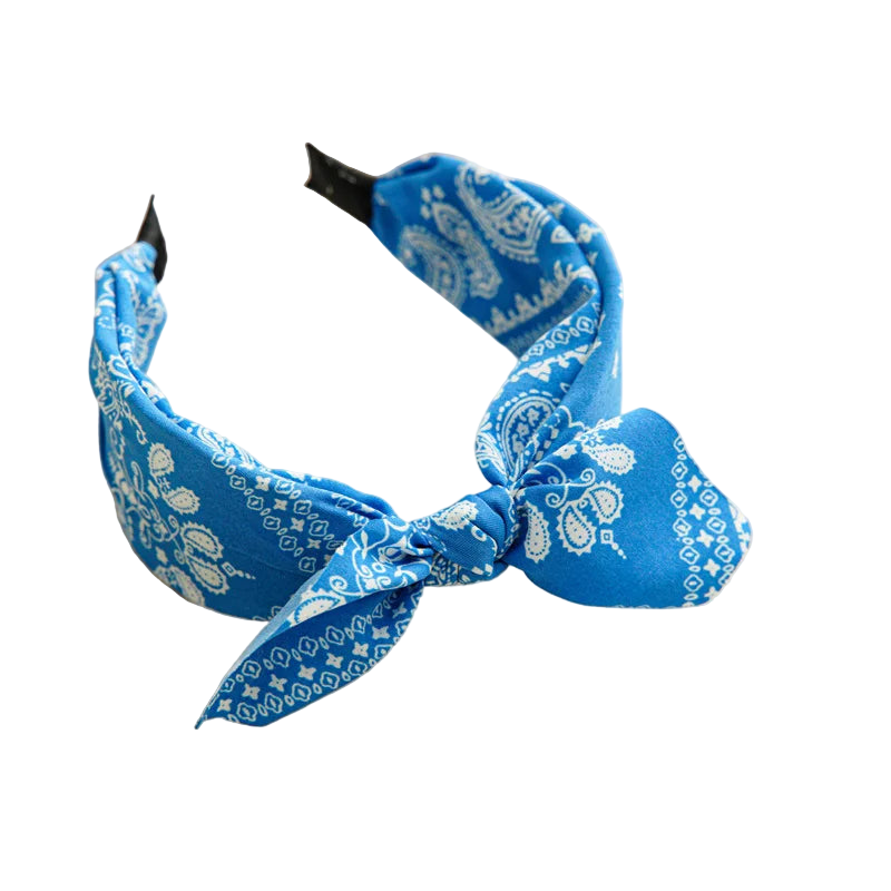 Blue bandana headband with white patterns on a beige tray.